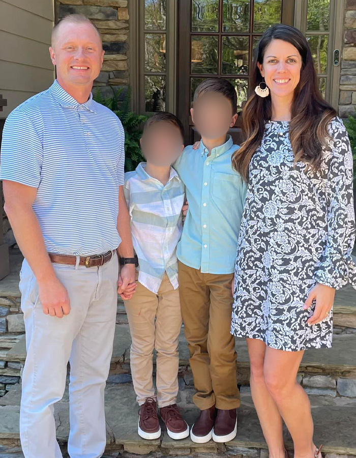 Family photo outside home, showing a teacher with his wife and two children before prank incident involving teens.