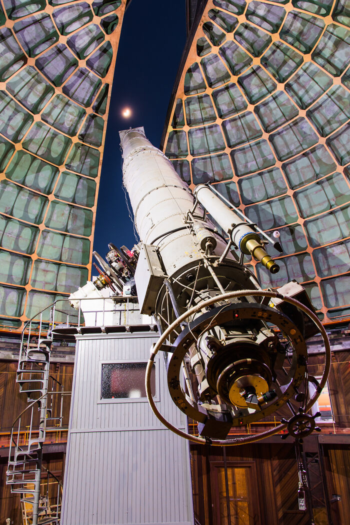 Large vintage telescope inside an observatory dome under night sky, illustrating an interesting rabbit hole exploration theme.