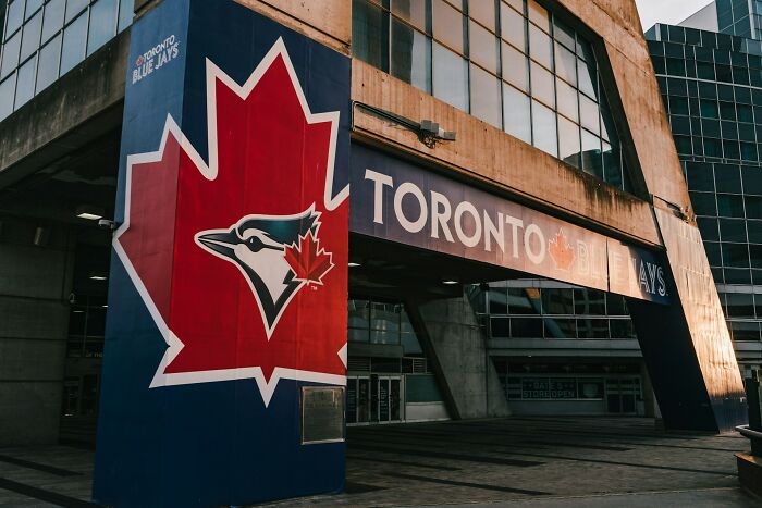 Toronto Blue Jays logo and signage on a building exterior, highlighting vanished cultural truths in home countries.