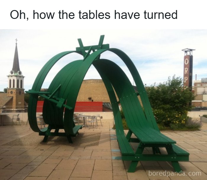 Unique green outdoor bench with curved design and table labeled entertaining memes for meme lovers to function properly.