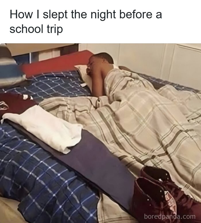 Person lying in bed with clothes and shoes laid out, nostalgic 1990s and 2000s vibes about excitement before a trip.