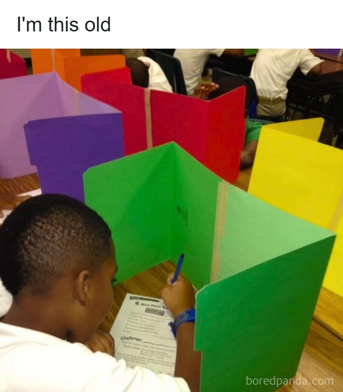 Child in classroom with colorful privacy dividers working on a worksheet, evoking nostalgia for 1990s and 2000s school days.