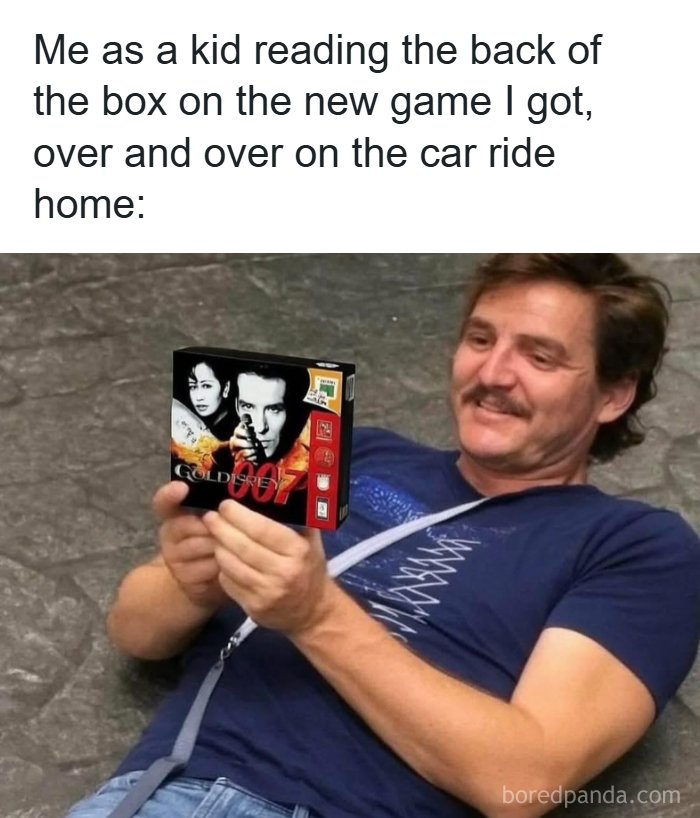 Man lying down smiling while reading the back of a 90s video game box showing parts of 90s life nostalgia.