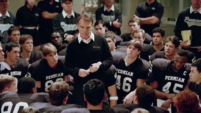 High school football team meeting with coach, illustrating American things people believe only exist in movies.