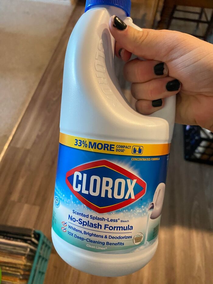 Hand holding a bottle of Clorox bleach featuring no-splash formula and whitening benefits, related to payback stories.