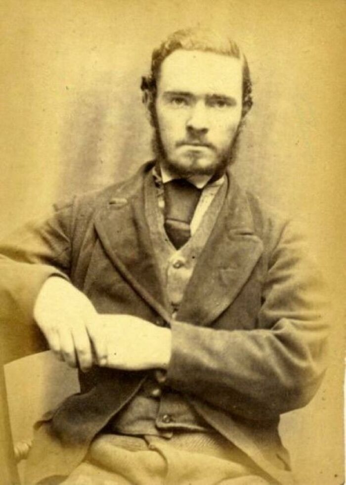 Vintage sepia photograph of a man in 19th-century attire, evoking old photographs and strange time travel theories.