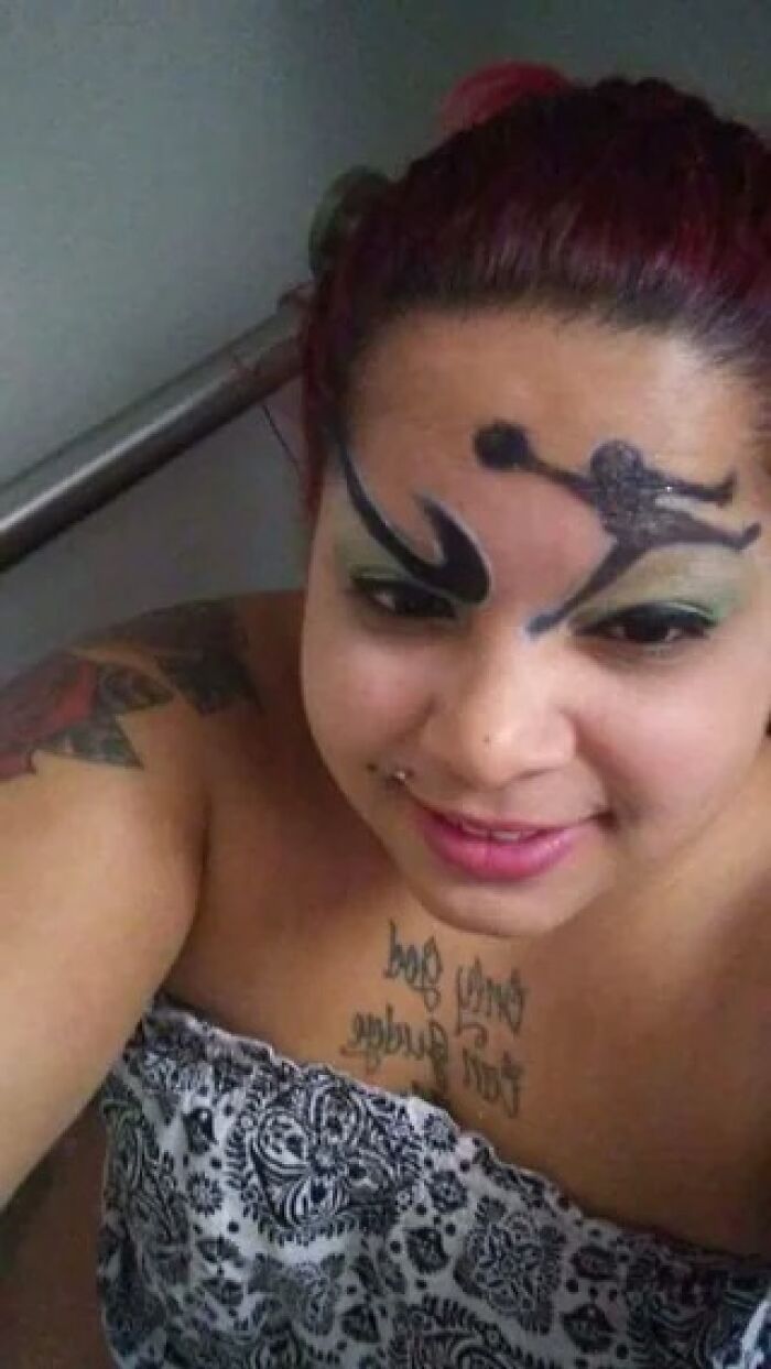 Woman with crazy eyebrows shaped like a dancer painted creatively on her face, showing unique eyebrow art style.