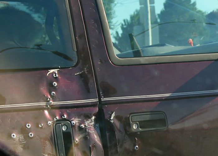 Car door riddled with bullet holes, illustrating fake facts people believed only because of movies about unrealistic violence.