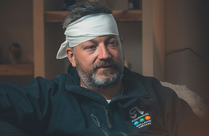 Man with a head bandage sitting indoors, illustrating fake facts people believed only because of movies.