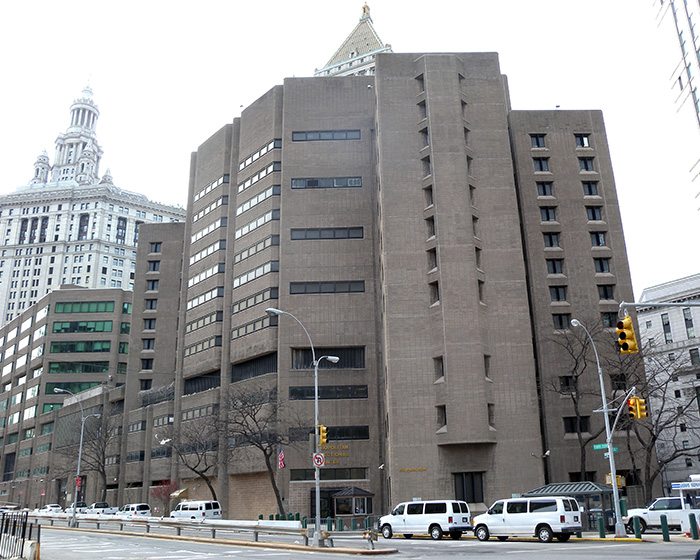 Metropolitan Correctional Center exterior with traffic lights and vehicles relating to Epstein guard incriminating words.