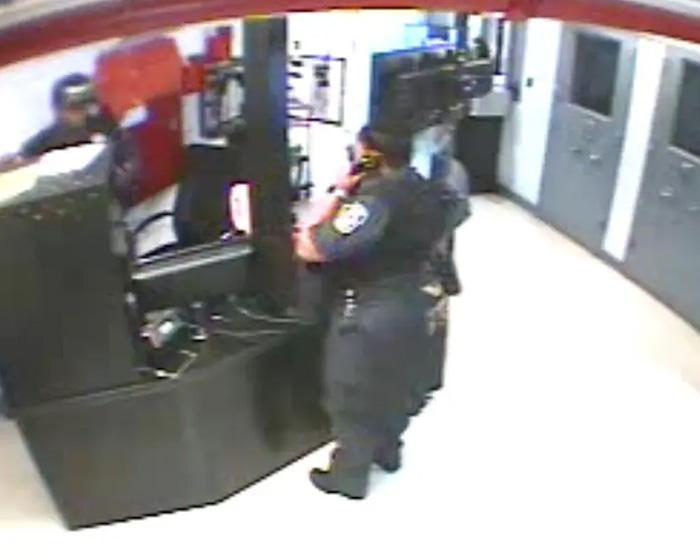 Security guard inside a facility speaking on a phone, related to Epstein guard&rsquo;s incriminating words about his passing.