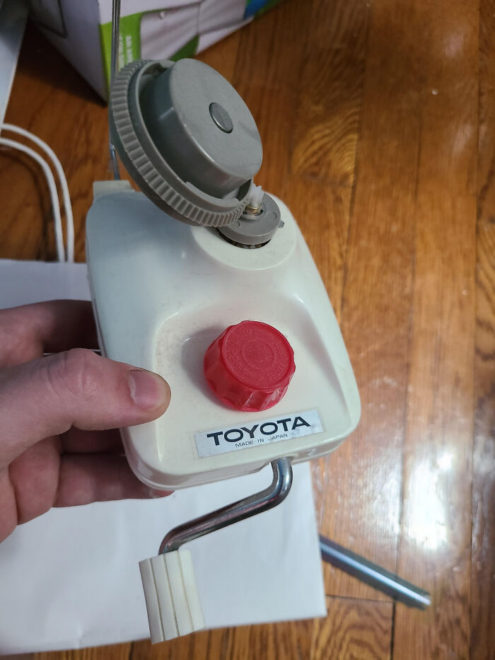 Hand holding a vintage Toyota branded device, an example from the internet solving the mystery of unidentified objects.
