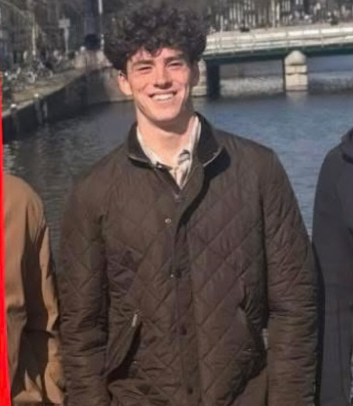 Young man smiling near a river in Spain, linked to suspicious footage in the vanishing of American student.