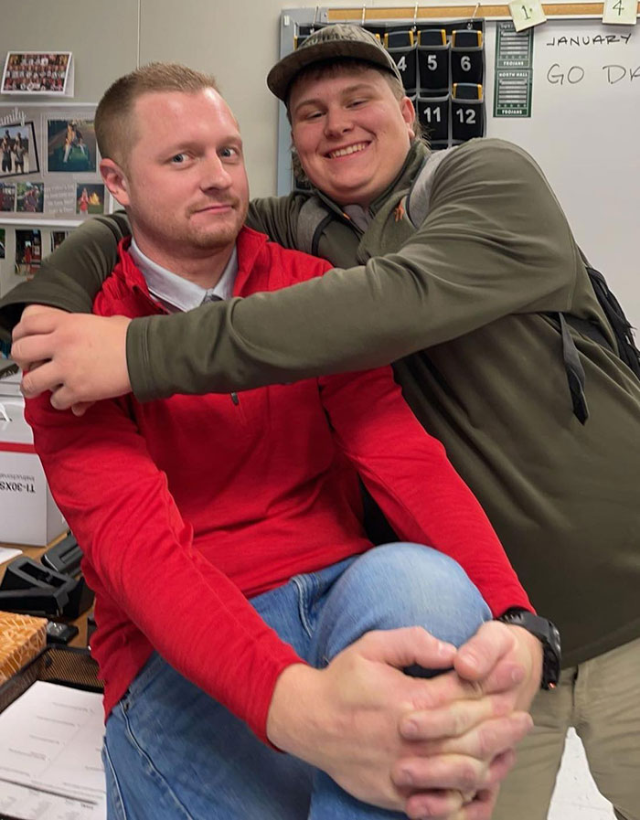 High school teacher and student sharing a lighthearted moment in a classroom before a prank gone wrong incident.