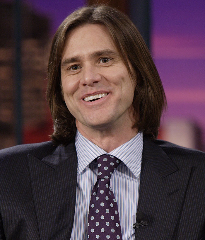 Man with medium-length brown hair wearing a pinstripe suit and polka dot tie discusses Jim Carrey face medical verdict Man with medium-length brown hair wearing a pinstripe suit and polka dot tie discusses Jim Carrey face medical verdict