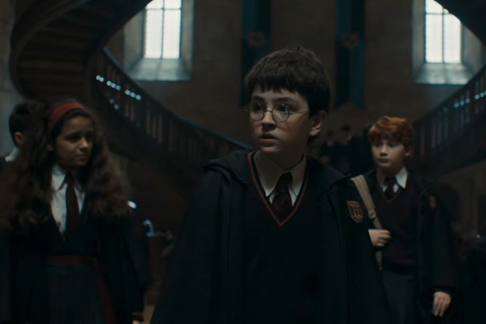 Young students in Hogwarts uniforms walking in a dimly lit hall, related to Harry Potter reboot backlash and J.K. Rowling. Young students in Hogwarts uniforms walking in a dimly lit hall, related to Harry Potter reboot backlash and J.K. Rowling.