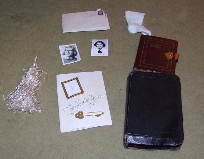 Assorted vintage items including photos, a journal, and a tassel found in an old home with creepy history.