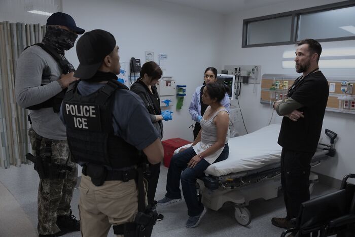 ICE officers and medical staff in a tense hospital room scene from the controversial Pitt episode viewed by fans. ICE officers and medical staff in a tense hospital room scene from the controversial Pitt episode viewed by fans.