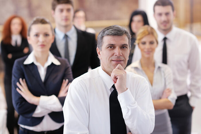 Group of former jurors in professional attire, expressing doubt and loss of faith in the justice system in a courtroom setting.