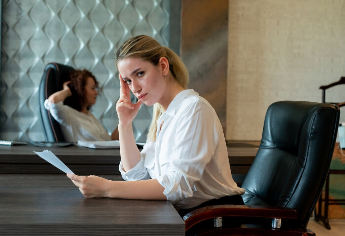 Two former jurors in a jury room, one visibly frustrated, reflecting moments that caused loss of faith in the justice system.