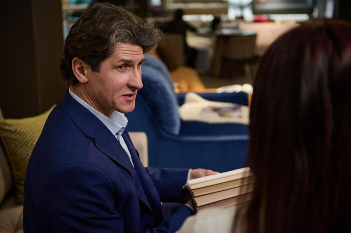 Man in blue suit discussing moments in the jury room that caused loss of faith in the justice system.