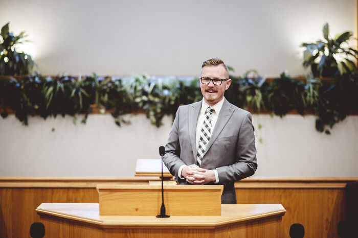 Man in a suit standing at a courtroom podium, representing moments in the jury room that lost faith in justice system.