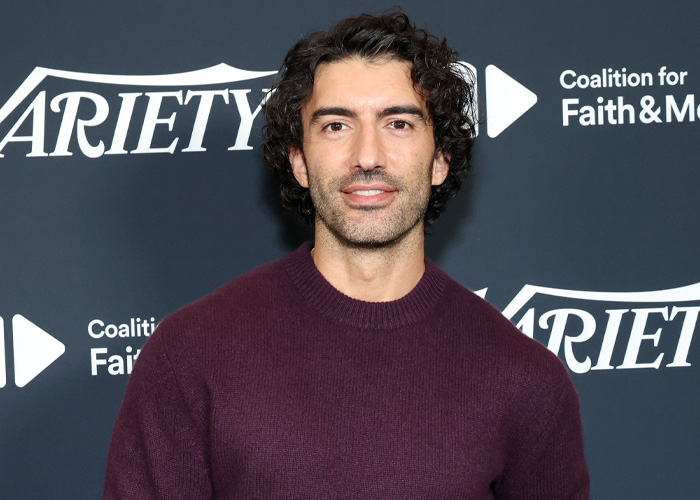 Justin Baldoni at a Variety event, wearing a maroon sweater, linked to legal battle with Blake Lively discussions.