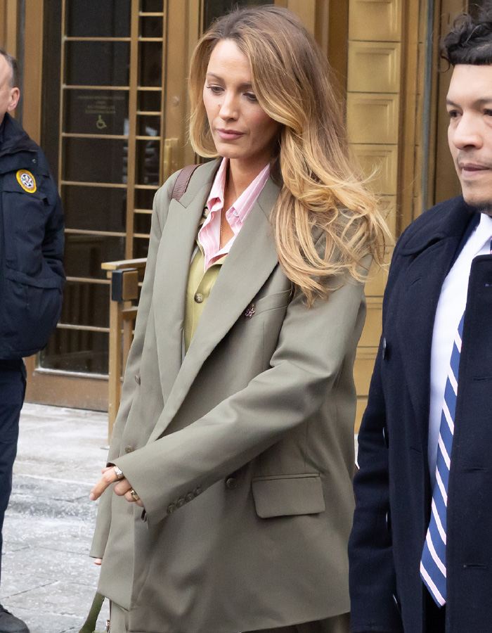 Blake Lively walking outside a courthouse with long hair and beige blazer amid Justin Baldoni legal battle developments.