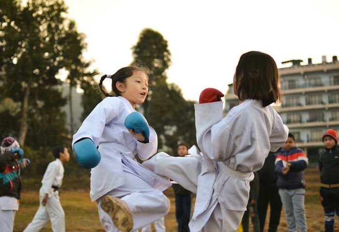 Two children practicing karate outdoors, illustrating the concept of shaky industries that can collapse unexpectedly.