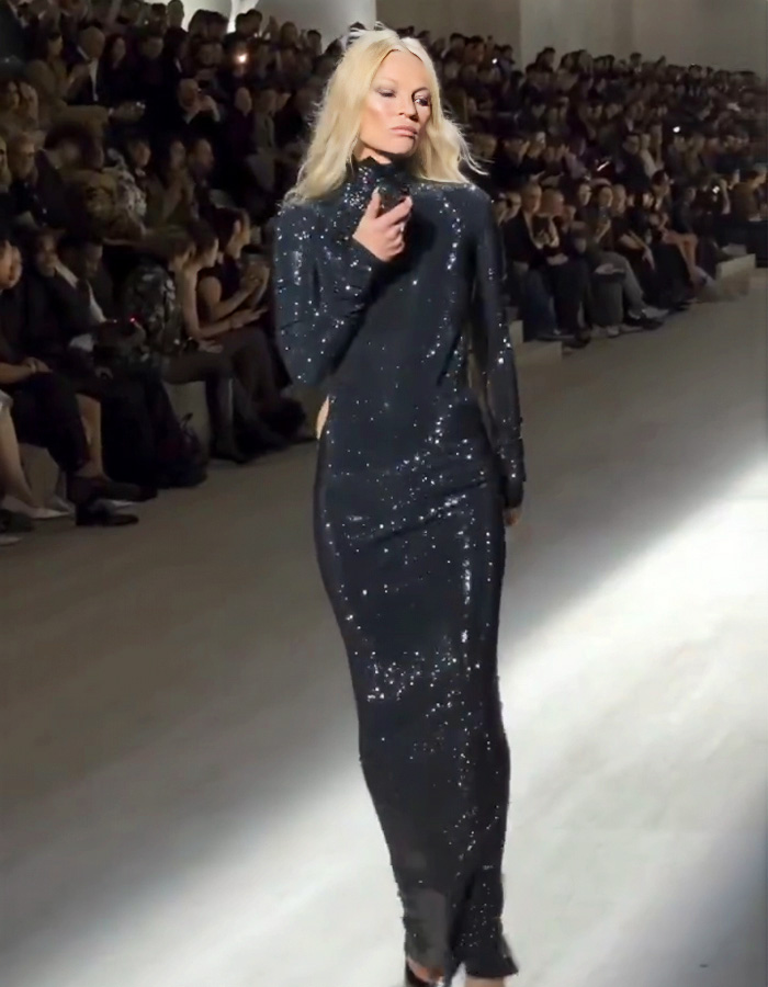 Kate Moss wearing a revealing dress on the runway at the Gucci show, captivating and dividing fashion fans.