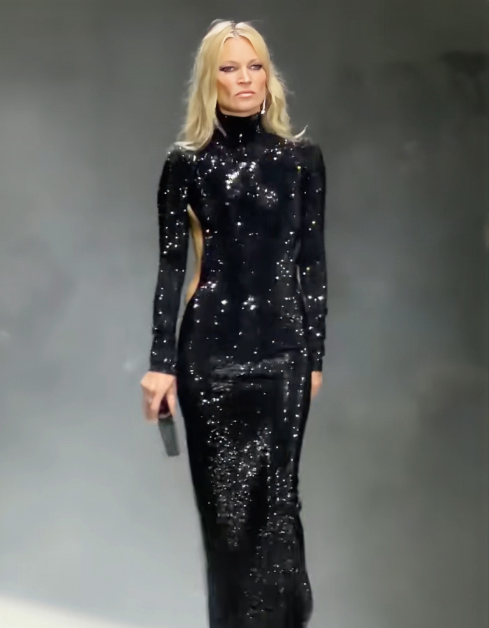Kate Moss wearing a revealing black sequined dress with side cutouts at the Gucci fashion show runway.