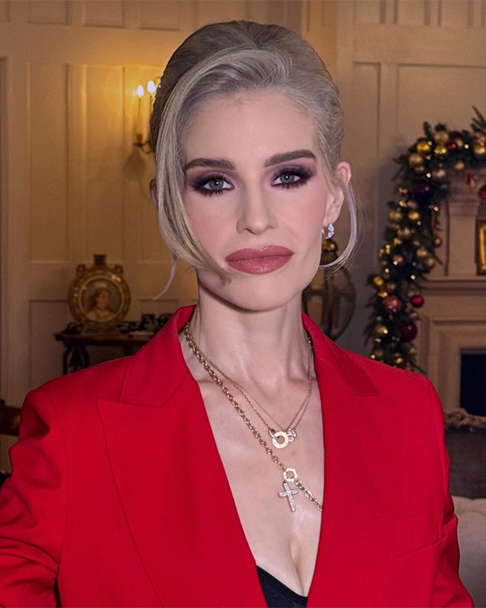 Kelly Osbourne in a red blazer with dramatic makeup, showcasing her transformation amid reports of splitting from fiancé Sid Wilson.