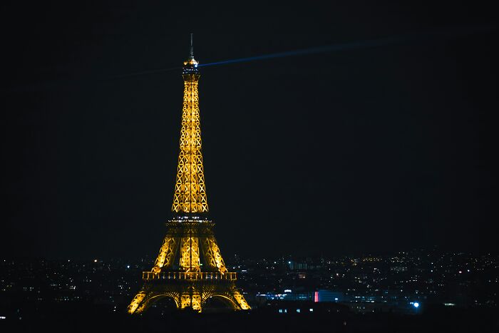 Eiffel Tower illuminated at night, highlighting popular myths about iconic landmarks around the world.