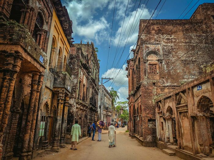 Street scene with old buildings and people walking, illustrating hilarious and bizarre instances of culture shock abroad.