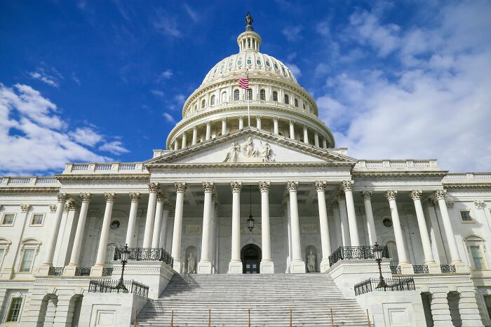 US Capitol building under a partly cloudy sky, symbolizing historic and impactful discoveries like the moon landing.