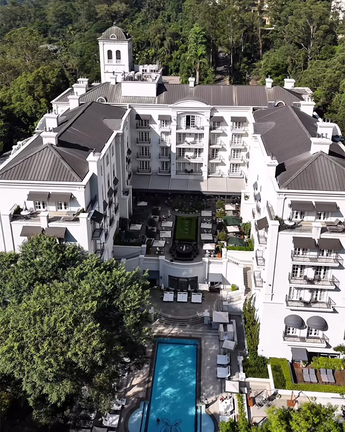 Aerial view of luxury hotel with courtyard and pool, involved in Chappell Roan and Jude Law's daughter security guard scandal. Aerial view of luxury hotel with courtyard and pool, involved in Chappell Roan and Jude Law's daughter security guard scandal.