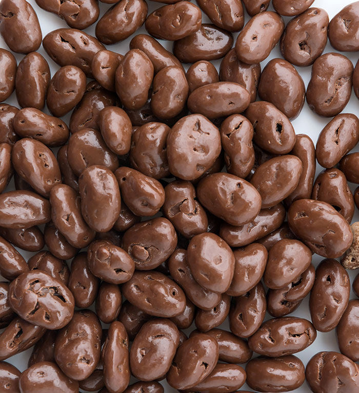 Chocolate-covered nuts or raisins closely packed, symbolizing eerie and odd stories about unexplained experiences.