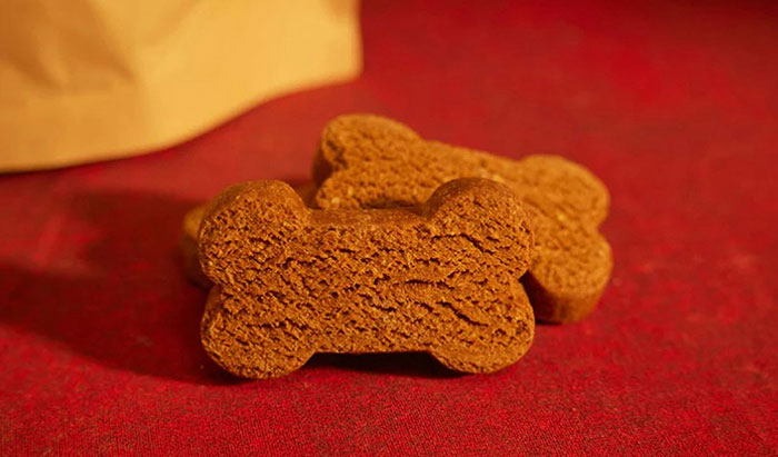 Bone-shaped dog treats on a red surface, representing eerie and odd stories about unexplained experiences.