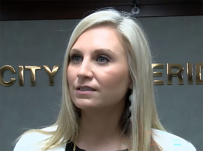 Former Louisiana mayor at a city office, addressing her fate after the pool party incident with son's friend.