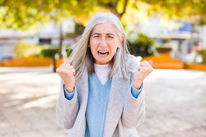 Frustrated woman expressing distress outdoors representing breakup freedom and being forced to watch ex&rsquo;s nephew.