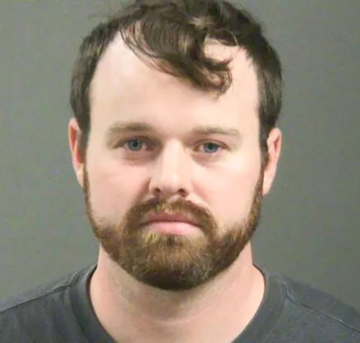 Joseph Duggar looking serious in a mugshot photo, related to past comments on brother Josh&rsquo;s misconduct arrest.