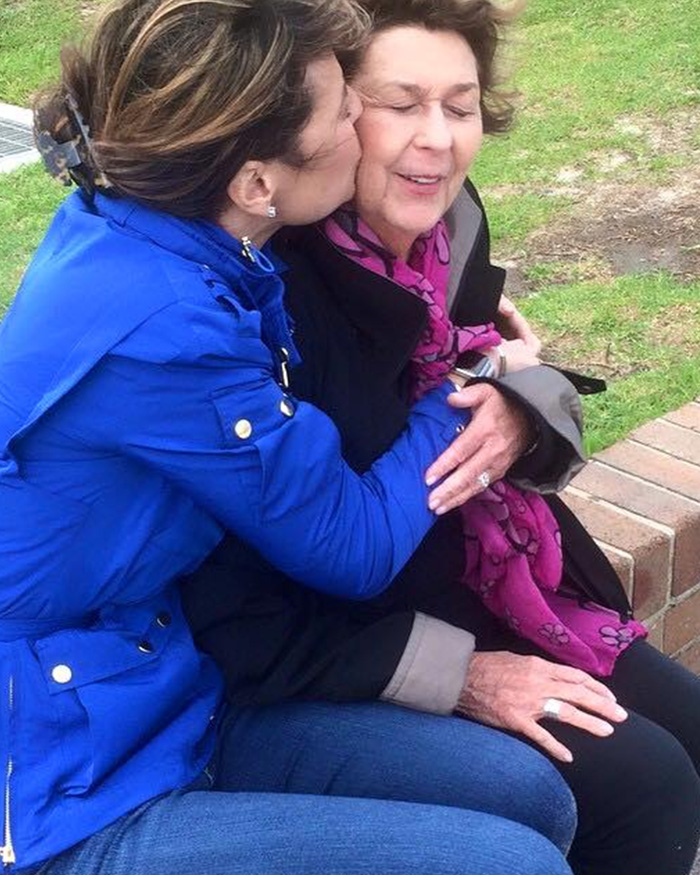 Woman in blue jacket hugging and kissing an older woman, related to FBI analysis of Nancy Guthrie case theories and new lead.