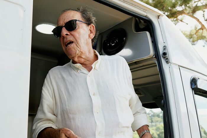 Man wearing sunglasses and a white shirt, looking shocked, inside a vehicle during one of the scariest experiences.