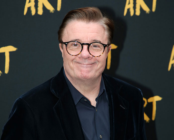 Acting legend wearing glasses and dark suit at a red carpet event reacting to ballet and opera remark controversy.