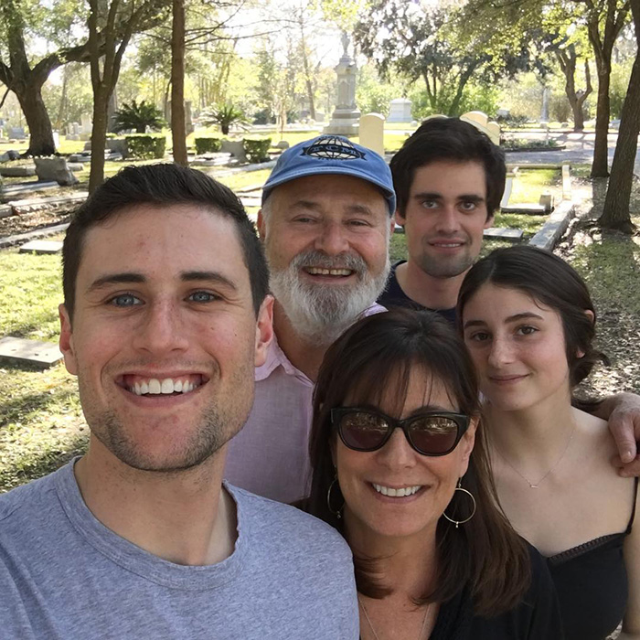 Group selfie outdoors with five people smiling, illustrating Nick Reiner&rsquo;s account raising alarming questions and signs.