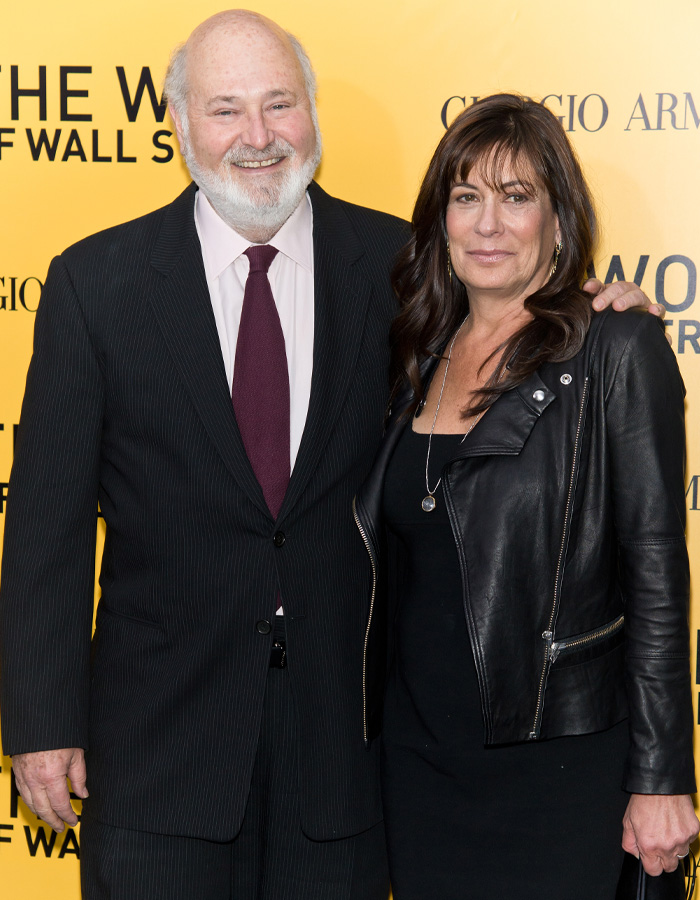 Two people posing at an event, a man in a suit and tie and a woman in a black dress and leather jacket, Nick Reiner&rsquo;s account.