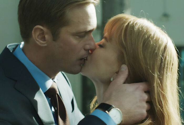 Nicole Kidman and Alexander Skarsg&aring;rd sharing a close on-screen kiss in a dramatic scene.
