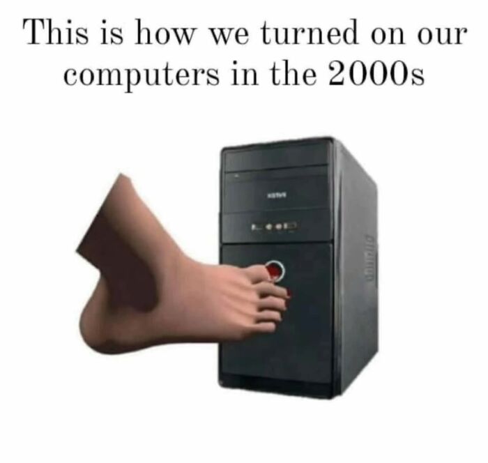 Foot pressing the power button on a 2000s computer tower, a nostalgic image for millennials' childhood memories.