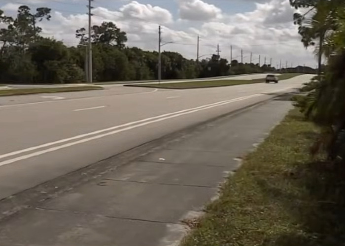 Empty suburban road with a sidewalk under a cloudy sky, related to nurse's chilling final text case.