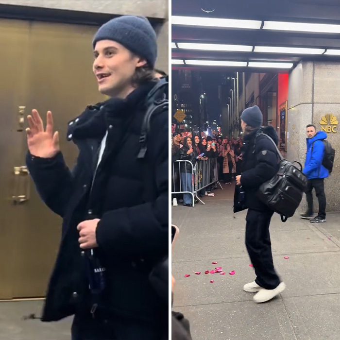 Olympic hero Jack Hughes wearing a beanie and black jacket awkwardly engaging with a crowd outside NBC studios at night. Olympic hero Jack Hughes wearing a beanie and black jacket awkwardly engaging with a crowd outside NBC studios at night.